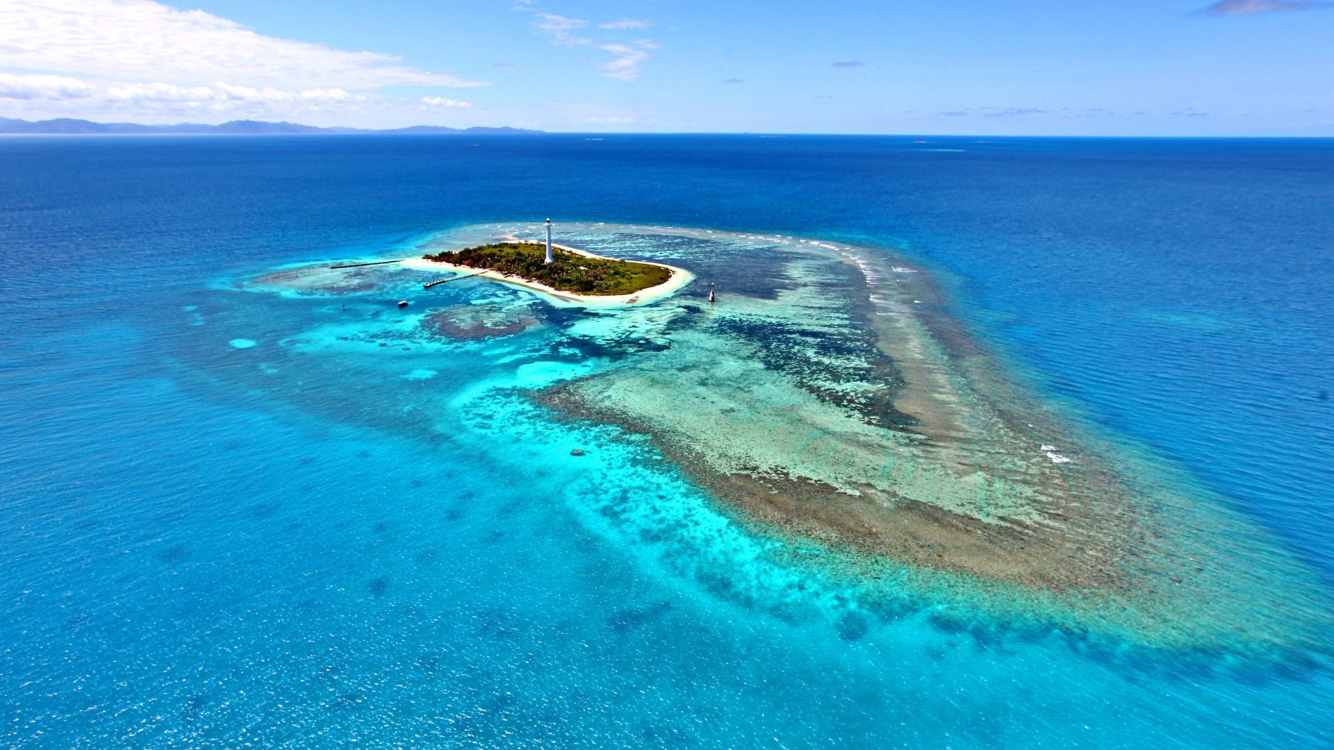 Blue water with a small green island