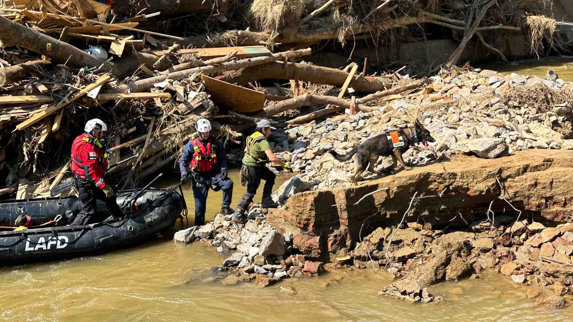 Rescue workers on rafts among the wreckage