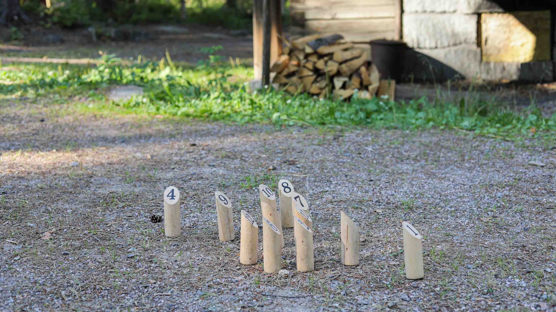 A series of numbered pins stand on the ground for a game of mölkky, a traditional Finnish game.
