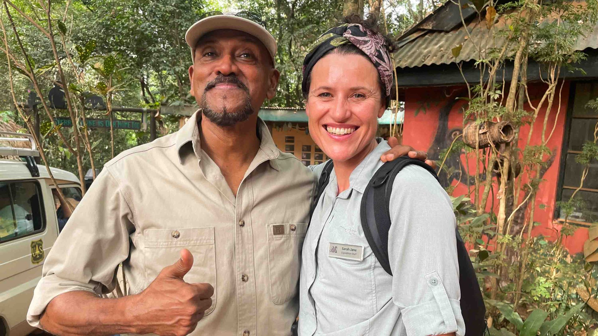 A woman and man smile to camera.