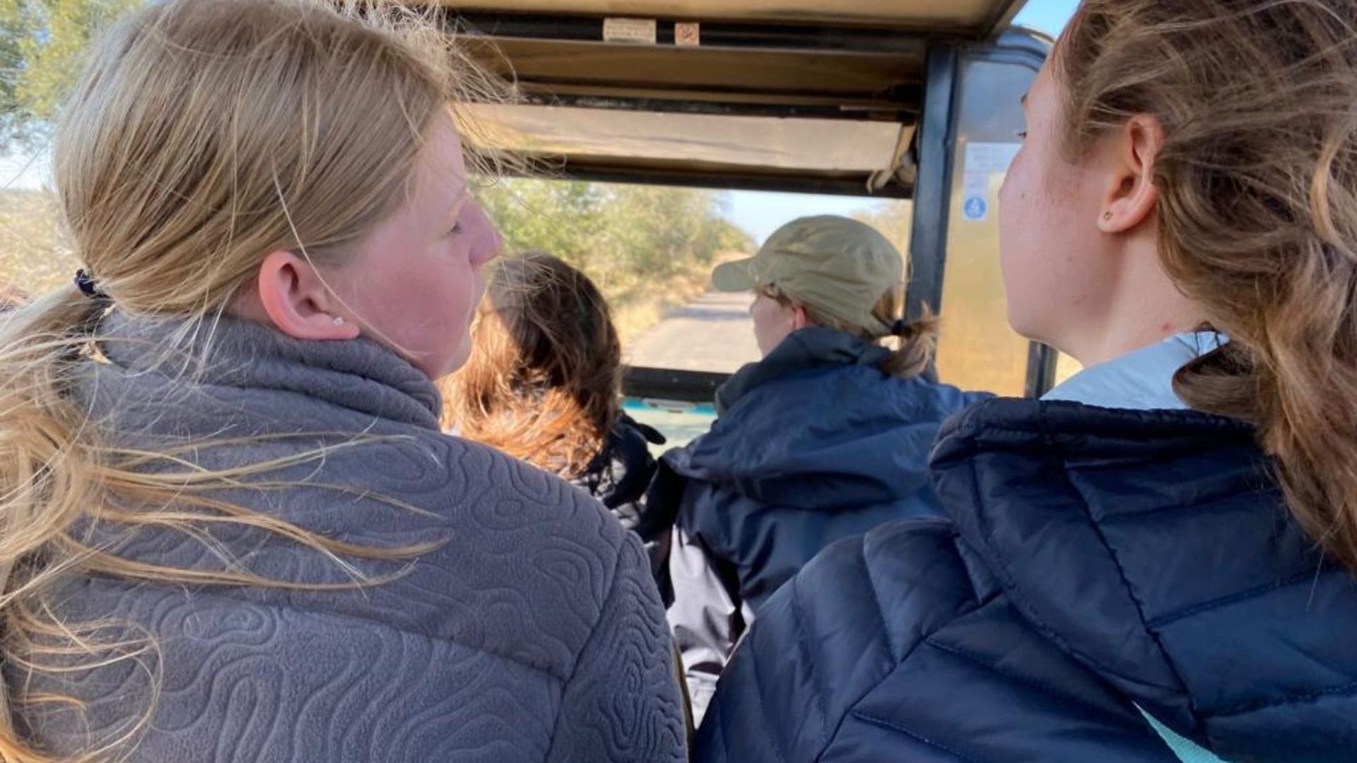 A group of travelers in a safari vehicle.