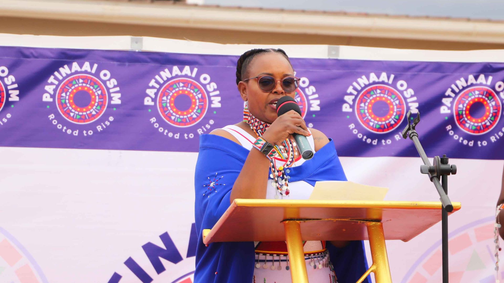 A woman speaks at a lectern.