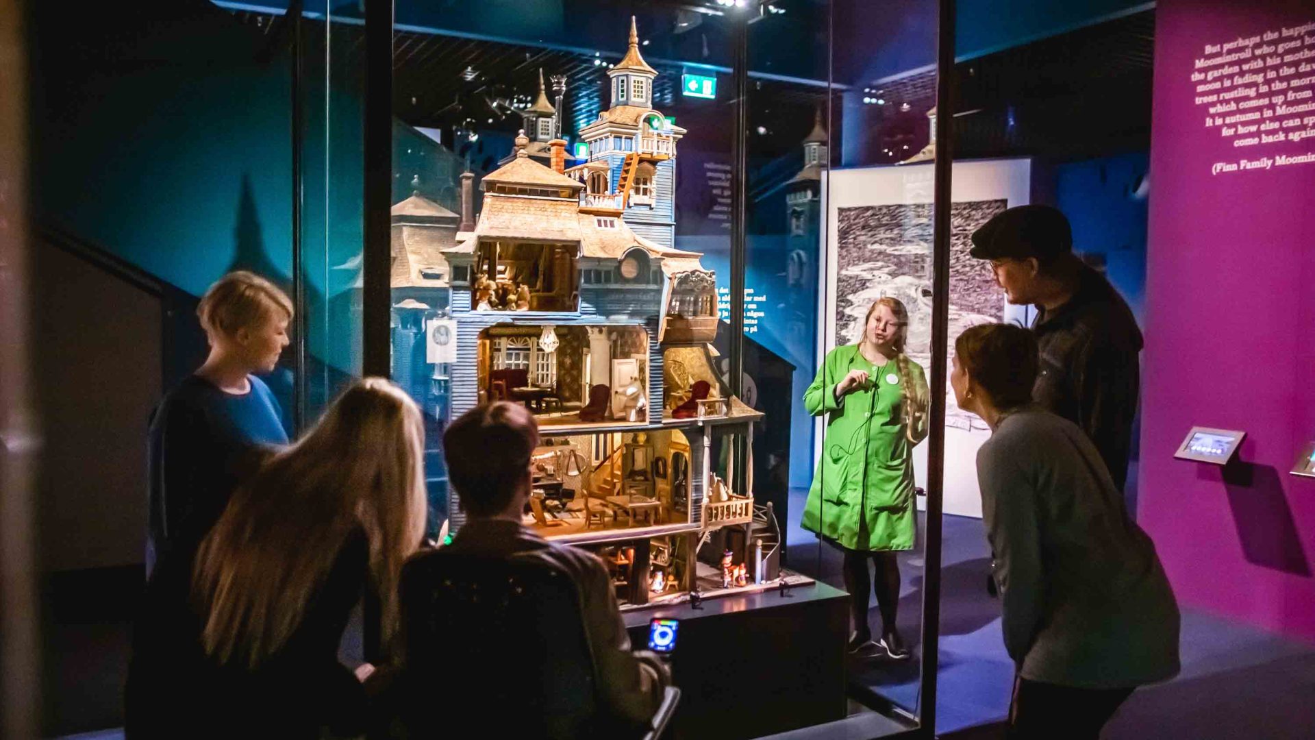 A guide talks about Moomins exhibits at an exhibition.