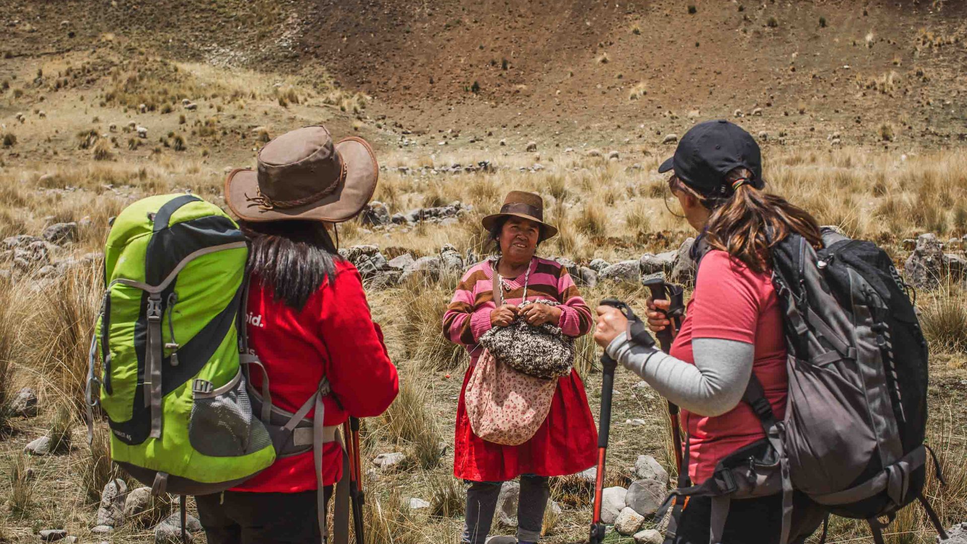 A local woman talks with two hikers.