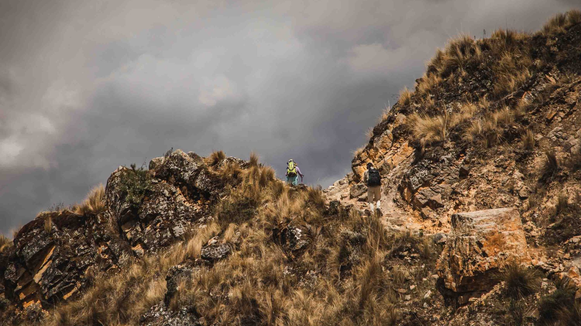 A hiker on the peak of a hill.