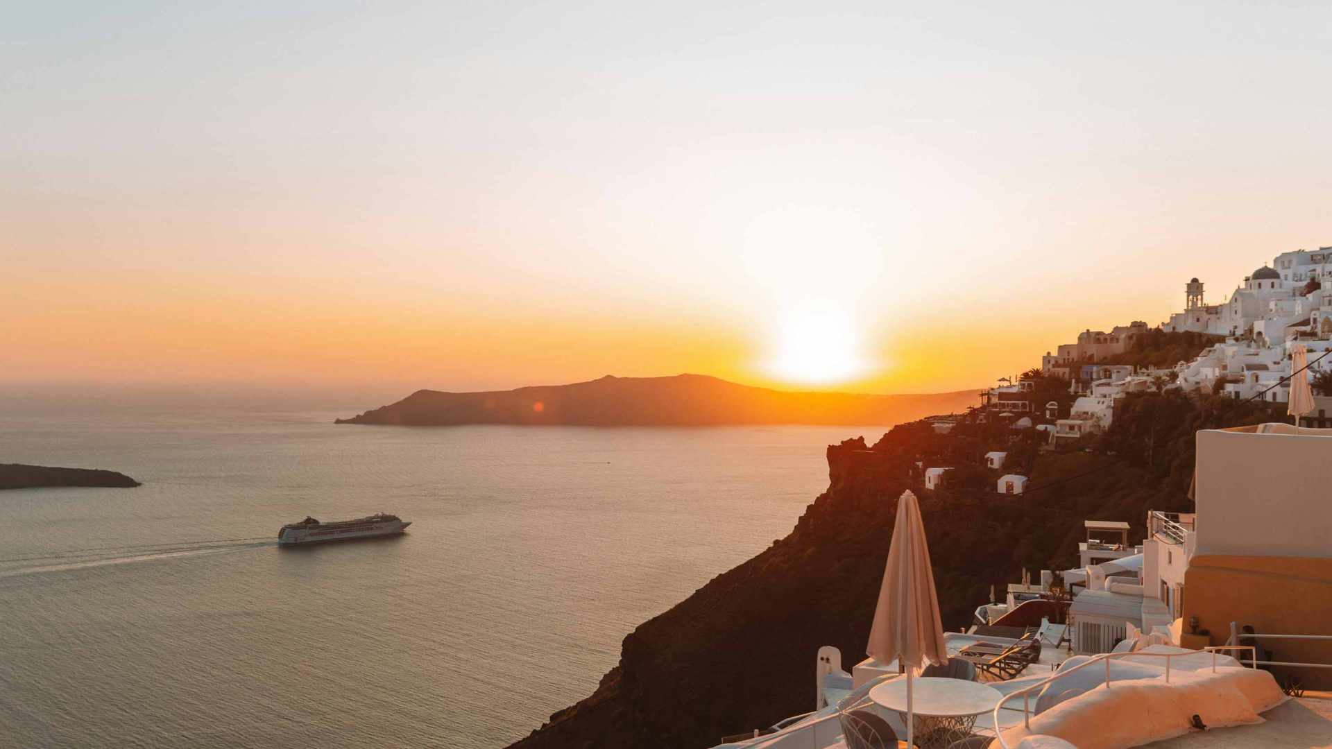 A cruise ships passes the Santorini coast.
