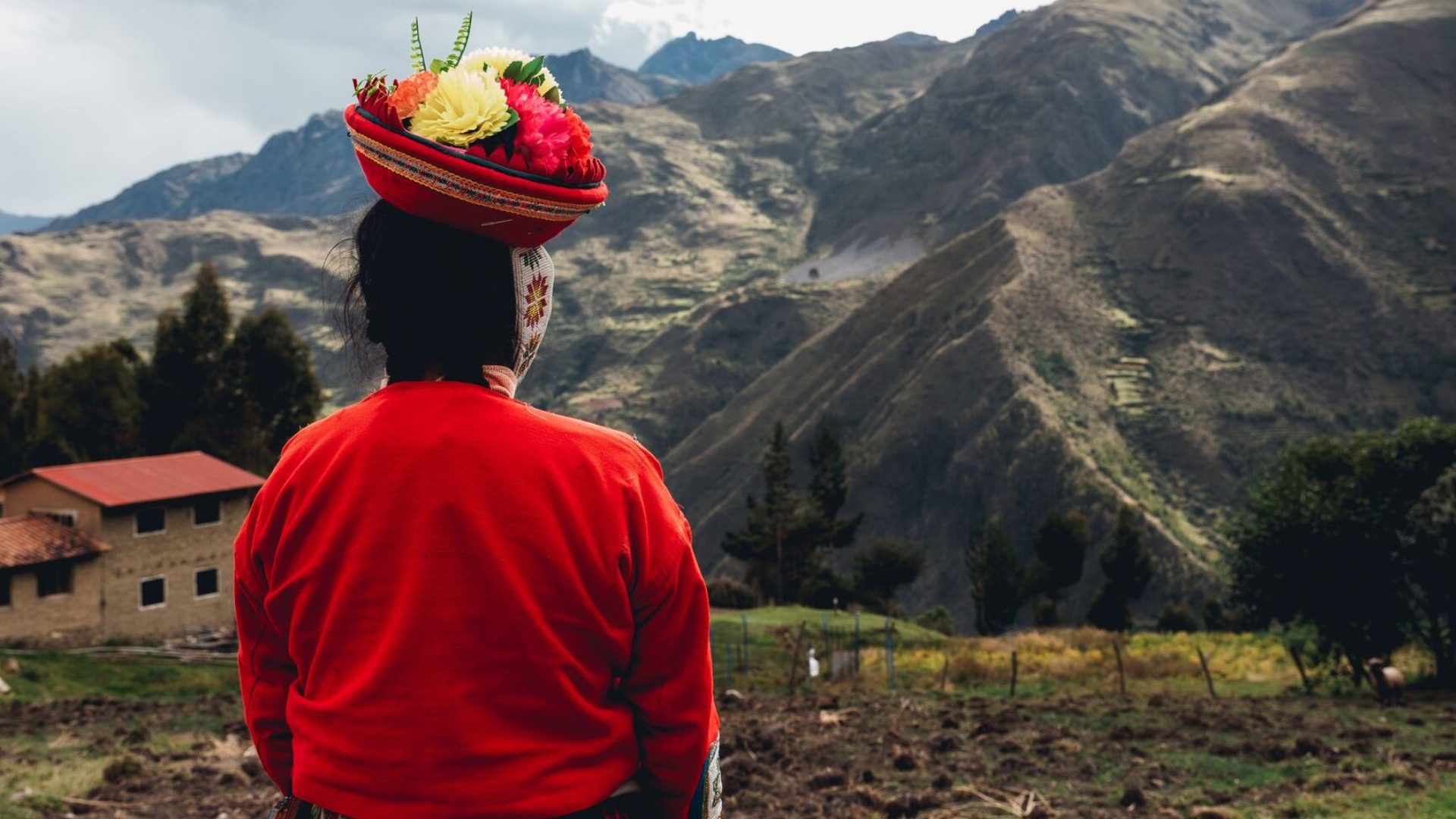 Indigenous Huilloc woman overlooks mountains in Peru's sacred valley