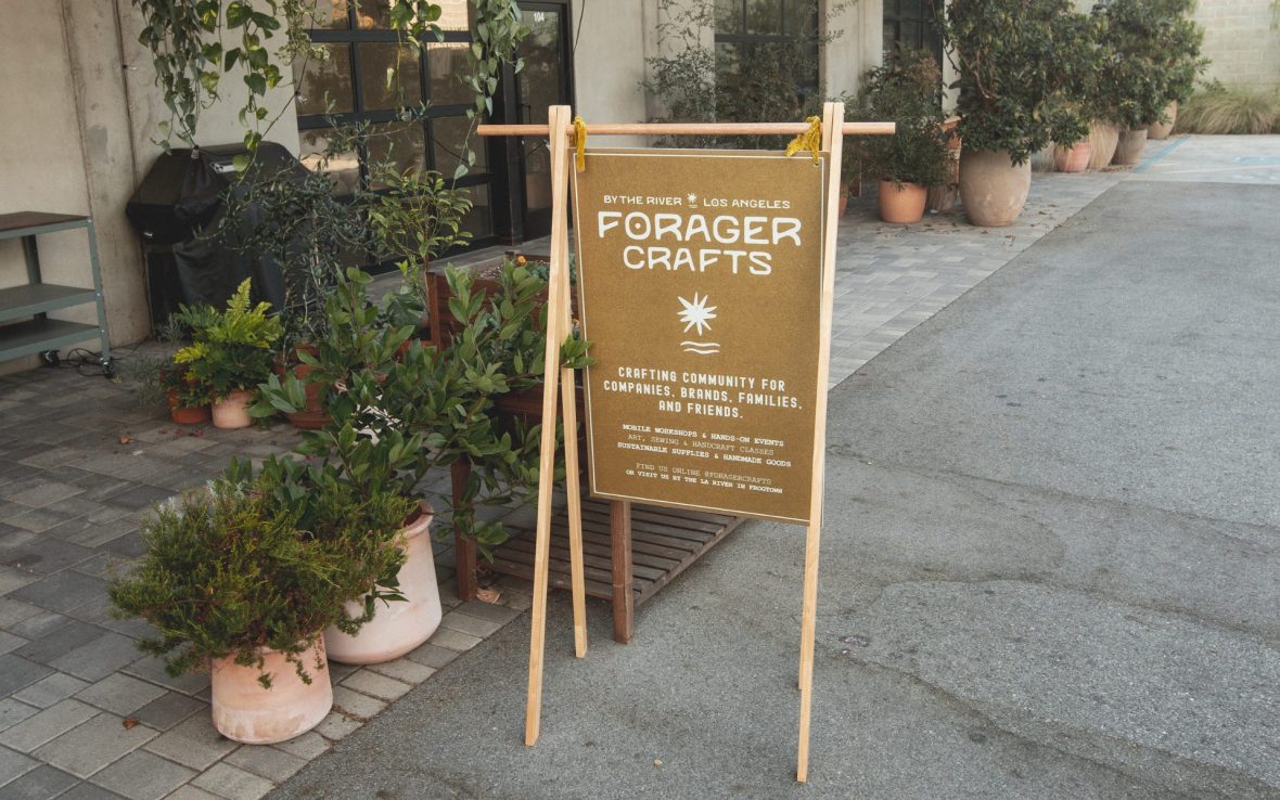 Brown messenger stand reading 'Forager Crafts'