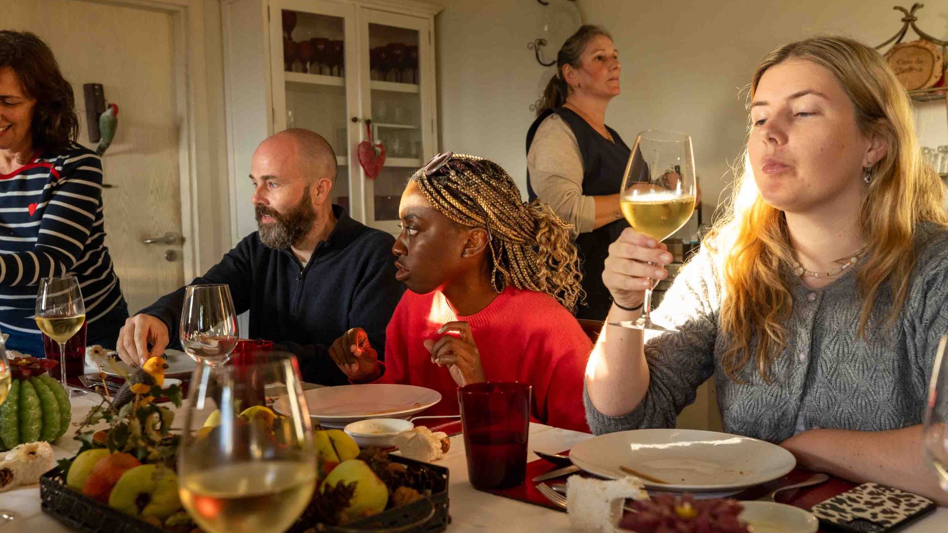 A group at a table eating and drinking.